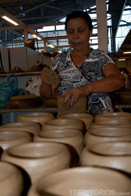 Woman shaping the pots